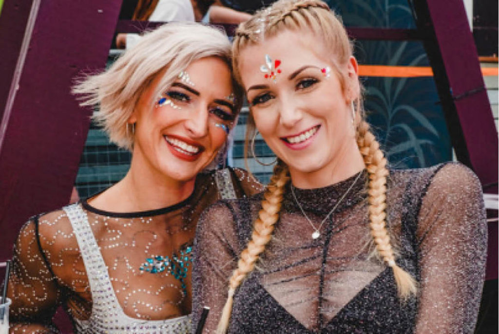 Photo of two women wearing sparkly makeup at Glitterfest